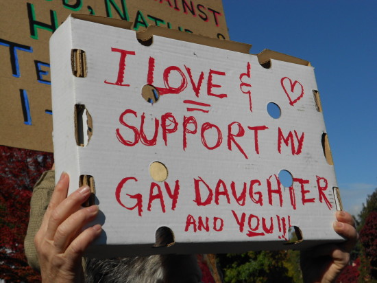 This woman's sign shows the love and support of her daughter - and I applaud her courage to stand right next to the man with the sign