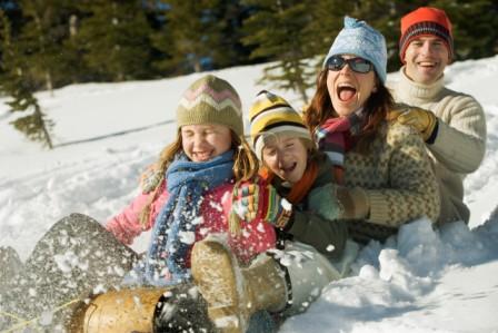 Family Sledding --- Image by © Royalty-Free/Corbis