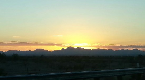 Desert sunset as seen from me twisting around in the seat to capture the moment.