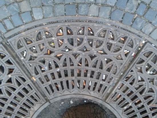 Grate filled with cigarette butts.
